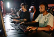 A group of young men immersed in a competitive esports gaming session indoors.