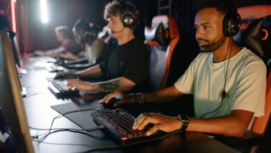 A group of young men immersed in a competitive esports gaming session indoors.
