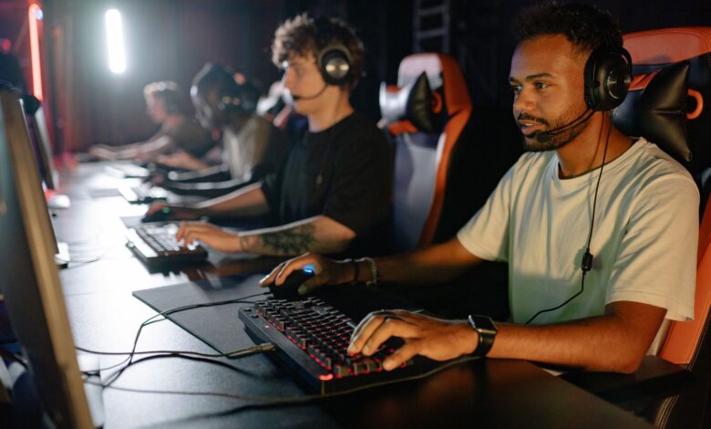 A group of young men immersed in a competitive esports gaming session indoors.