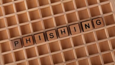 Wooden Scrabble tiles arranged to spell 'Phishing', illustrating online security concepts.