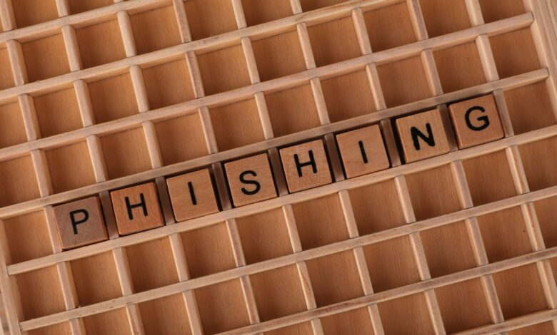 Wooden Scrabble tiles arranged to spell 'Phishing', illustrating online security concepts.