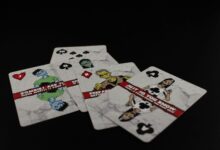 A dramatic still life of zombie-themed playing cards on a black background creates a spooky ambiance.