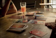 People playing a board game at a café table, capturing leisure and social interaction.