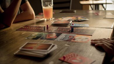 People playing a board game at a café table, capturing leisure and social interaction.
