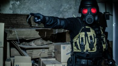 Dark and moody scene of a person in tactical gear and gas mask in an abandoned warehouse.