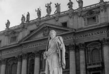Black and white photo of a statue at St. Peter's Basilica in Vatican City.