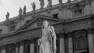 Black and white photo of a statue at St. Peter's Basilica in Vatican City.