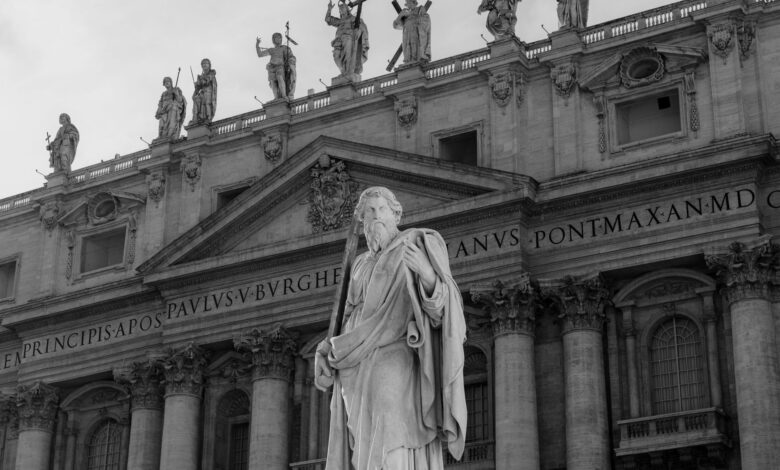 Black and white photo of a statue at St. Peter's Basilica in Vatican City.