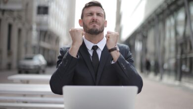 Confident businessman in Budapest celebrates success with a fist pump, reflecting a professional achievement.