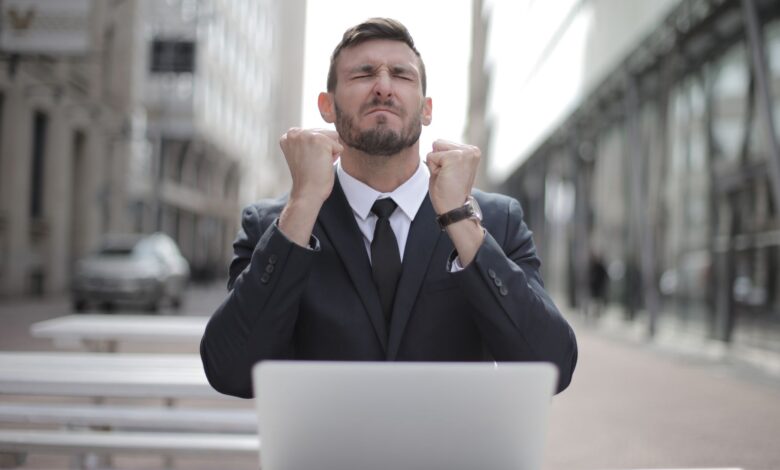 Confident businessman in Budapest celebrates success with a fist pump, reflecting a professional achievement.