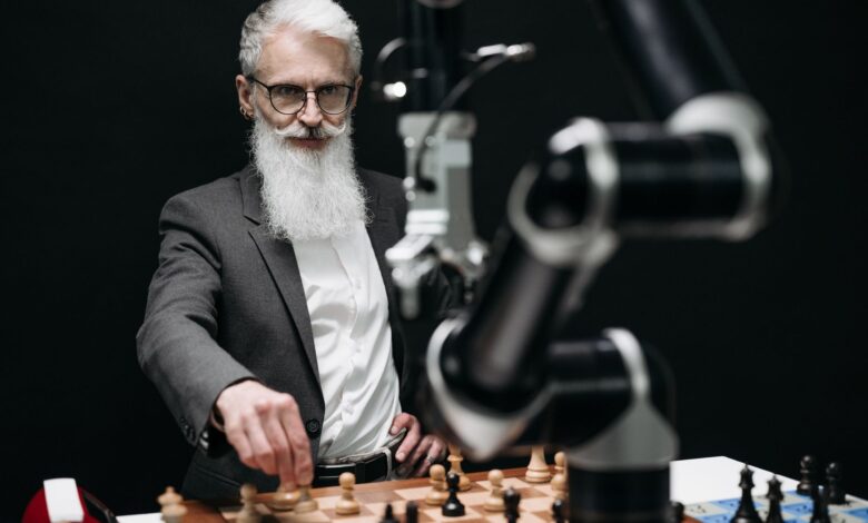 An older man engages in a strategic chess game with a robotic arm, illustrating the blend of tradition and technology.