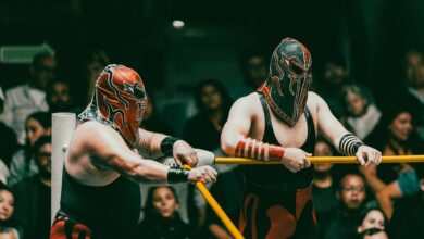 Masked wrestlers compete in an exciting Lucha Libre match before an engaged audience.
