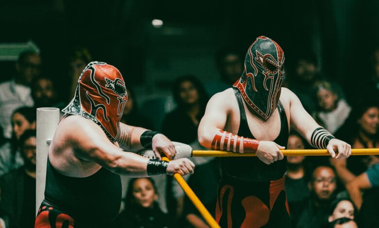 Masked wrestlers compete in an exciting Lucha Libre match before an engaged audience.