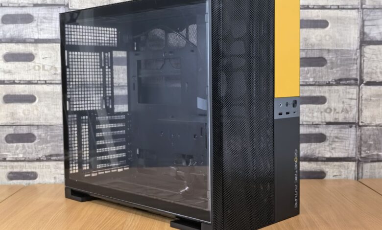 Modern computer case with glass panel, black and yellow design, on a wooden desk indoors.