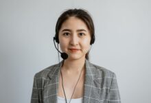 Portrait of a young female call center agent in a professional setting wearing a headset.