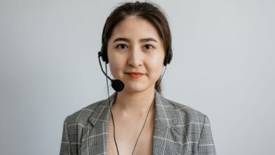 Portrait of a young female call center agent in a professional setting wearing a headset.