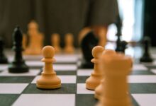 Close-up view of a strategic chess game with focus on pawns and pieces.