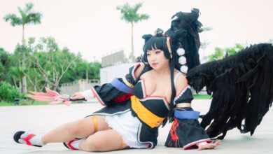 Cosplayer dressed as Nyotengu character from Dead or Alive, posing outdoors.