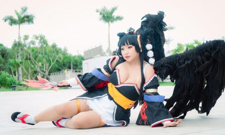 Cosplayer dressed as Nyotengu character from Dead or Alive, posing outdoors.