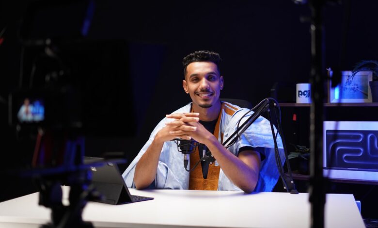 A confident podcaster speaking into a microphone in a modern studio setting.