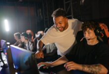 Gamers in a high-energy tournament setting enjoy competitive play with enthusiasm and teamwork.