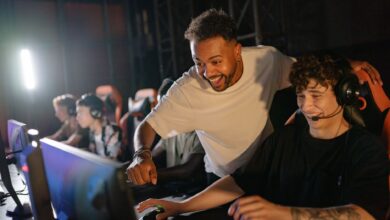 Gamers in a high-energy tournament setting enjoy competitive play with enthusiasm and teamwork.
