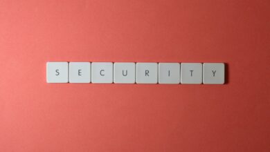 A conceptual image of the word 'security' spelled with keyboard keys on a red surface, providing copy space.
