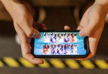 Close-up of hands playing a mobile game on a smartphone, showcasing the game's interface.