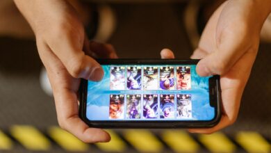Close-up of hands playing a mobile game on a smartphone, showcasing the game's interface.