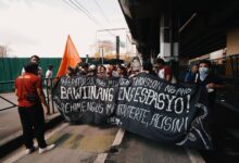 A group of protesters with masks and banner demanding change. Urban protest scene.