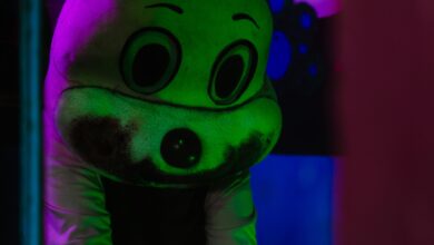 A spooky figure in a costume with dramatic lighting, creating a Halloween atmosphere.