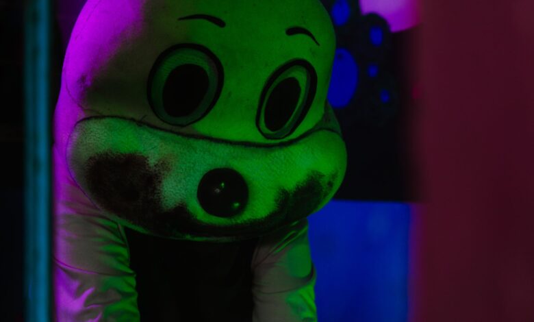 A spooky figure in a costume with dramatic lighting, creating a Halloween atmosphere.