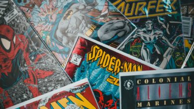 From above closeup of collection of assorted creative comic magazines with colorful illustrations spread out on surface