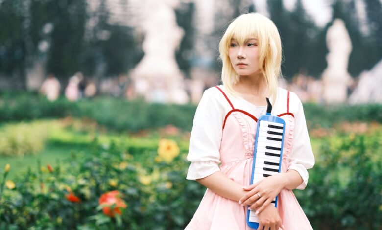 Captivating anime cosplay portrait featuring a person playing a melodica outdoors in Vietnam.