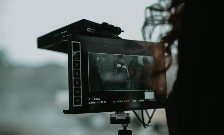 A close-up of professional filming equipment capturing a scene outdoors.