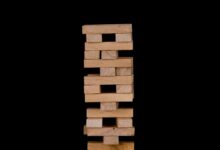 Close-up of wooden stacking blocks against a black backdrop.