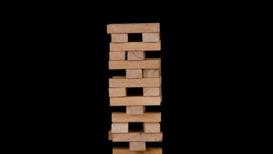 Close-up of wooden stacking blocks against a black backdrop.