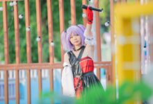 Young performer with lilac hair and a microphone at an outdoor festival, embracing youth culture.