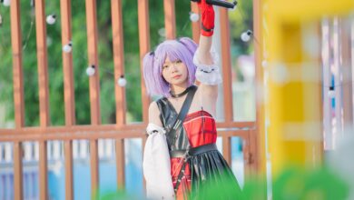 Young performer with lilac hair and a microphone at an outdoor festival, embracing youth culture.