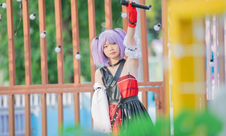 Young performer with lilac hair and a microphone at an outdoor festival, embracing youth culture.