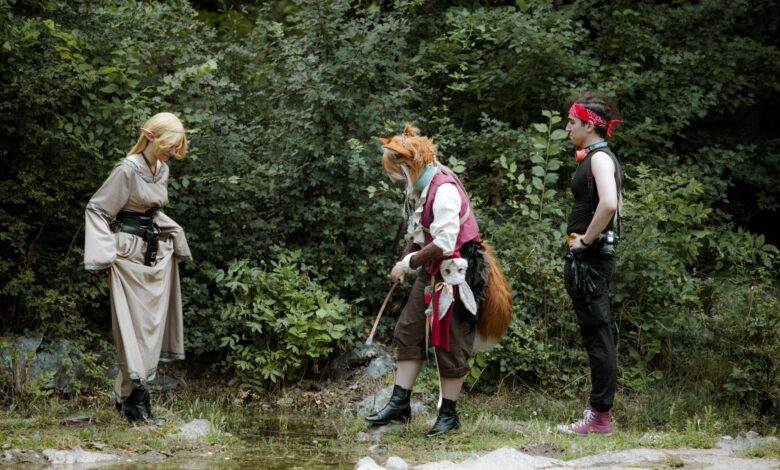 Fantasy characters engage in cosplay in a lush forest environment.