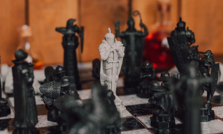 Close-up of medieval-themed chess pieces on a board, creating a strategic atmosphere.