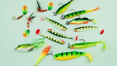 A vibrant collection of fishing lures on a light green surface, ideal for hobbyists.