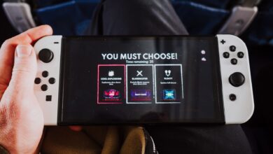 Close-up of a person holding a gaming console with an on-screen decision prompt.