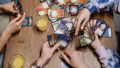 Close-up of friends playing a card game at a table, fostering socialization and togetherness.
