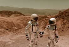 Two astronauts in spacesuits exploring a barren, sci-fi landscape.
