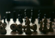 A dramatic representation of strategy and competition with chess pieces on a board.