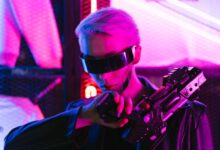 A stylish woman in cyberpunk attire poses with a futuristic gun under neon lights.