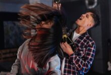 Two friends enjoying an intense Guitar Hero session, feeling the music.