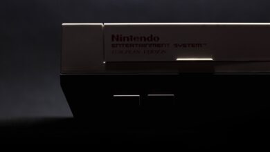A retro close-up shot of a classic Nintendo Entertainment System in low light.